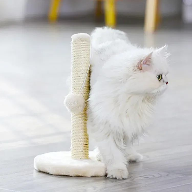 white cat rubbing against a sisal scratching post
